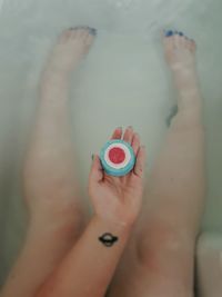 Close-up of woman hand with heart shape in water