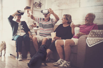 Cheerful family sitting on sofa at home