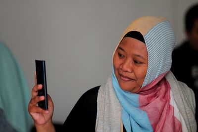 Woman wearing hijab using phone