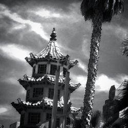 Low angle view of building against cloudy sky