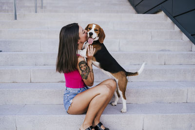 Full length of woman with dog on staircase