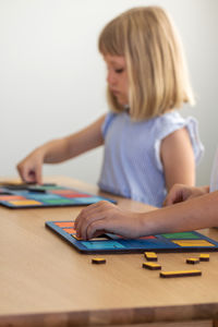 Boy playing with toy blocks on table