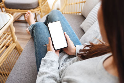 Midsection of woman using mobile phone