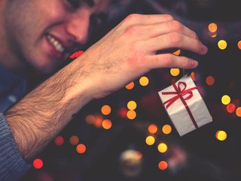 Close-up of man holding christmas decoration