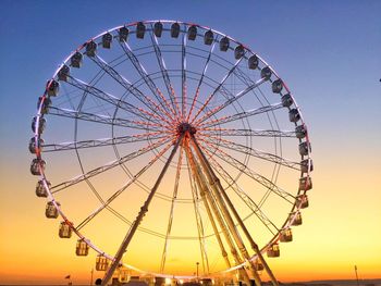 Low angle view of ferris wheel against sky