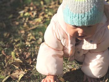 Close-up of baby crawling on field