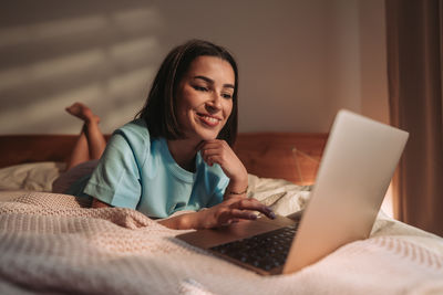 Young woman using laptop at home