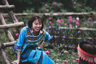 Portrait of a smiling woman sitting outdoors