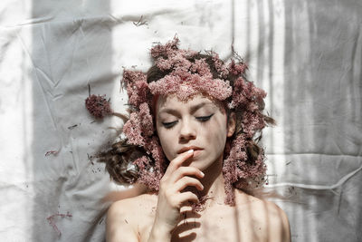 Portrait of woman with red flowers