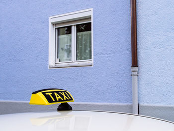 Close-up of taxi against building