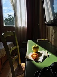 Empty chairs and table by window at home