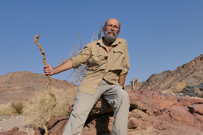 Senior man against blue sky in the desert 