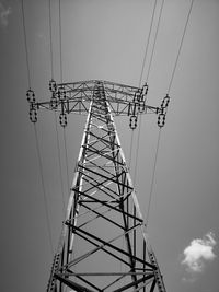 Low angle view of electricity pylon against clear sky