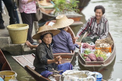 Vendors selling food at floating market