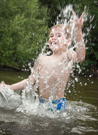 Happy boy playing in water
