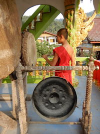 Full length of boy sitting in park