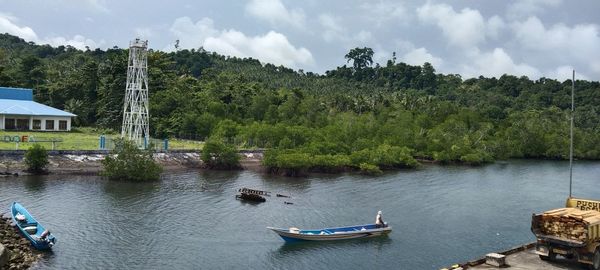 Boats in river against sky