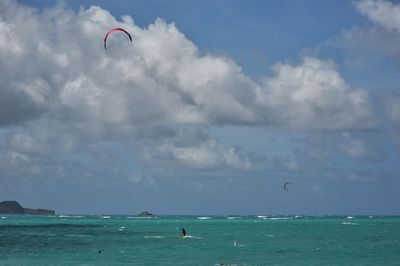 People kiteboarding on sea