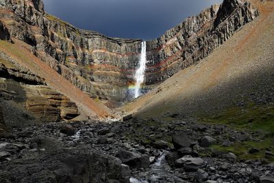 Scenic view of waterfall against sky