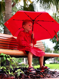 Portrait of boy sitting on bench