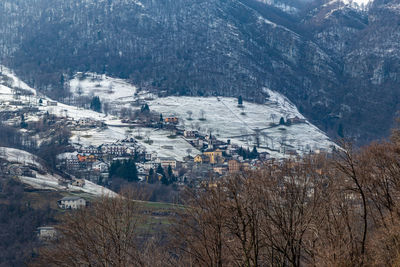 High angle view of townscape and snowcapped mountains