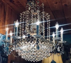 Low angle view of illuminated chandelier hanging on ceiling