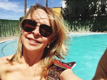 Portrait of smiling young woman in swimming pool