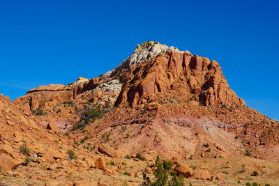 Rock formations against clear blue sky