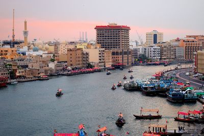 High angle view of people on river by buildings in city