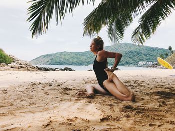 Woman exercising on beach