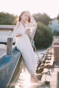 Portrait of young woman sitting on boat