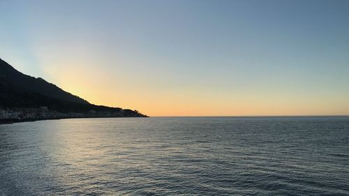 Scenic view of sea against clear sky during sunset