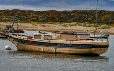 Boats moored in sea against sky