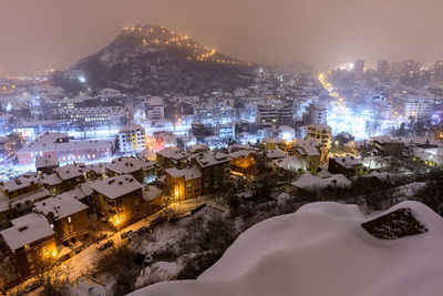 High angle view of illuminated buildings in city at night