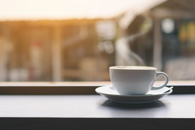 Coffee in cup on window sill