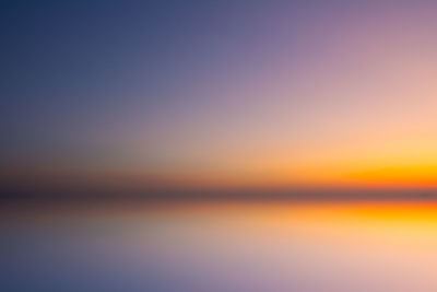 Scenic view of sea against romantic sky at sunset