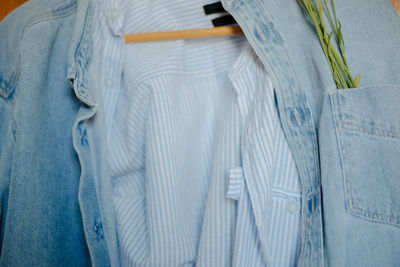 Close-up of clothes hanging on blue wall