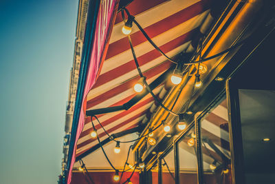 Low angle view of illuminated lights hanging from ceiling