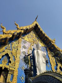 Low angle view of angel statue against building