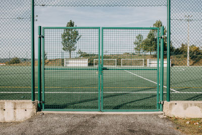 View of soccer field seen through fence