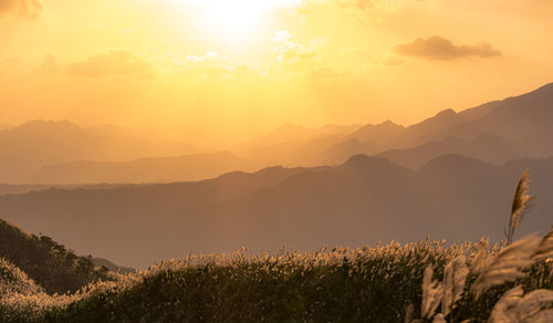 Scenic view of mountains against sky during sunset