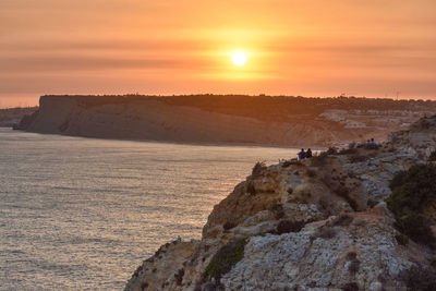 Scenic view of rocks against sky during sunset