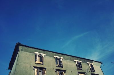 Low angle view of building against blue sky