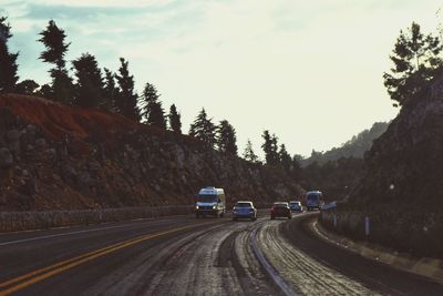 Cars on road against sky