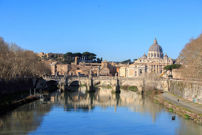 Landscape view of the tiber river, with reflection of old buildings and bridge, 