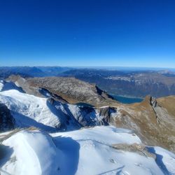 Scenic view of mountains against clear blue sky