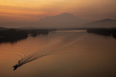 Scenic view of lake against sky during sunset
