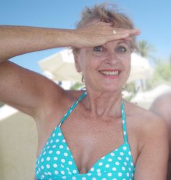 Portrait of smiling woman shielding eyes