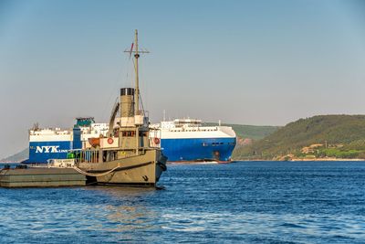 Ship sailing on sea against clear sky