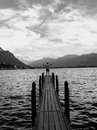 Pier over lake against sky